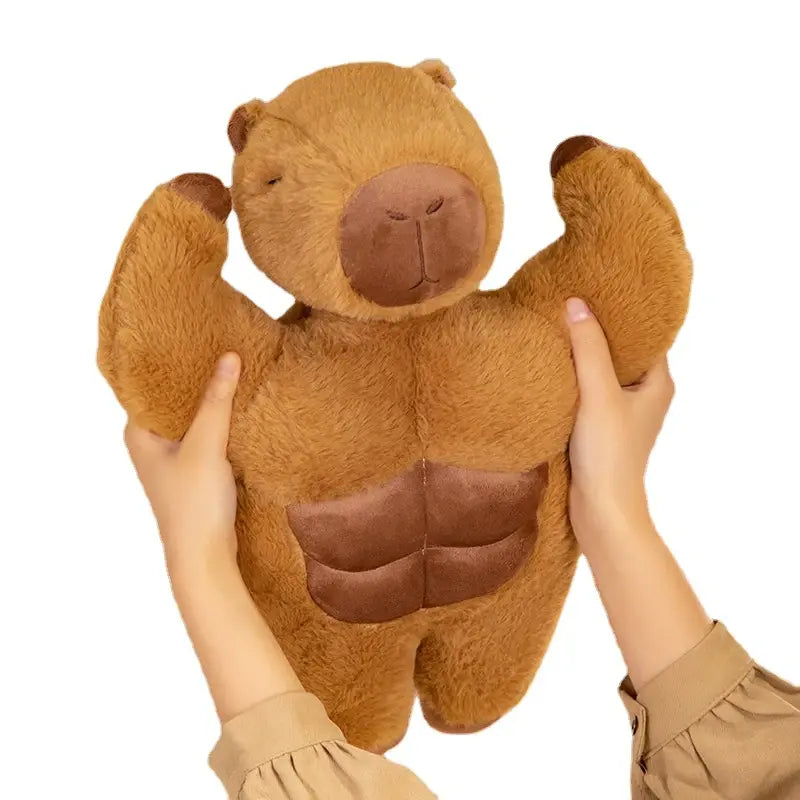 peluche capybara tenue par des mains