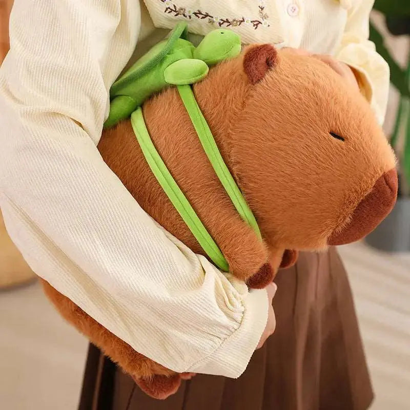 peluche capybara cartable sous le bras